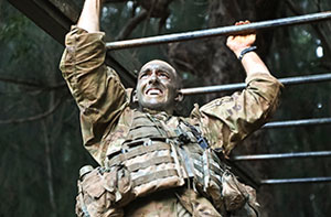 Soldier climbing on bars