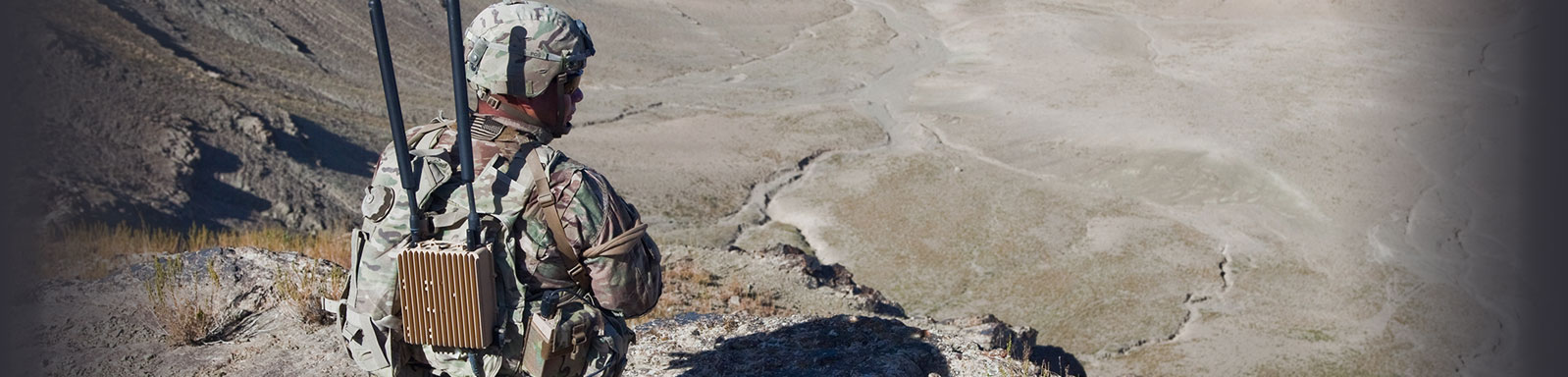 soldier looking out over a mountain view.